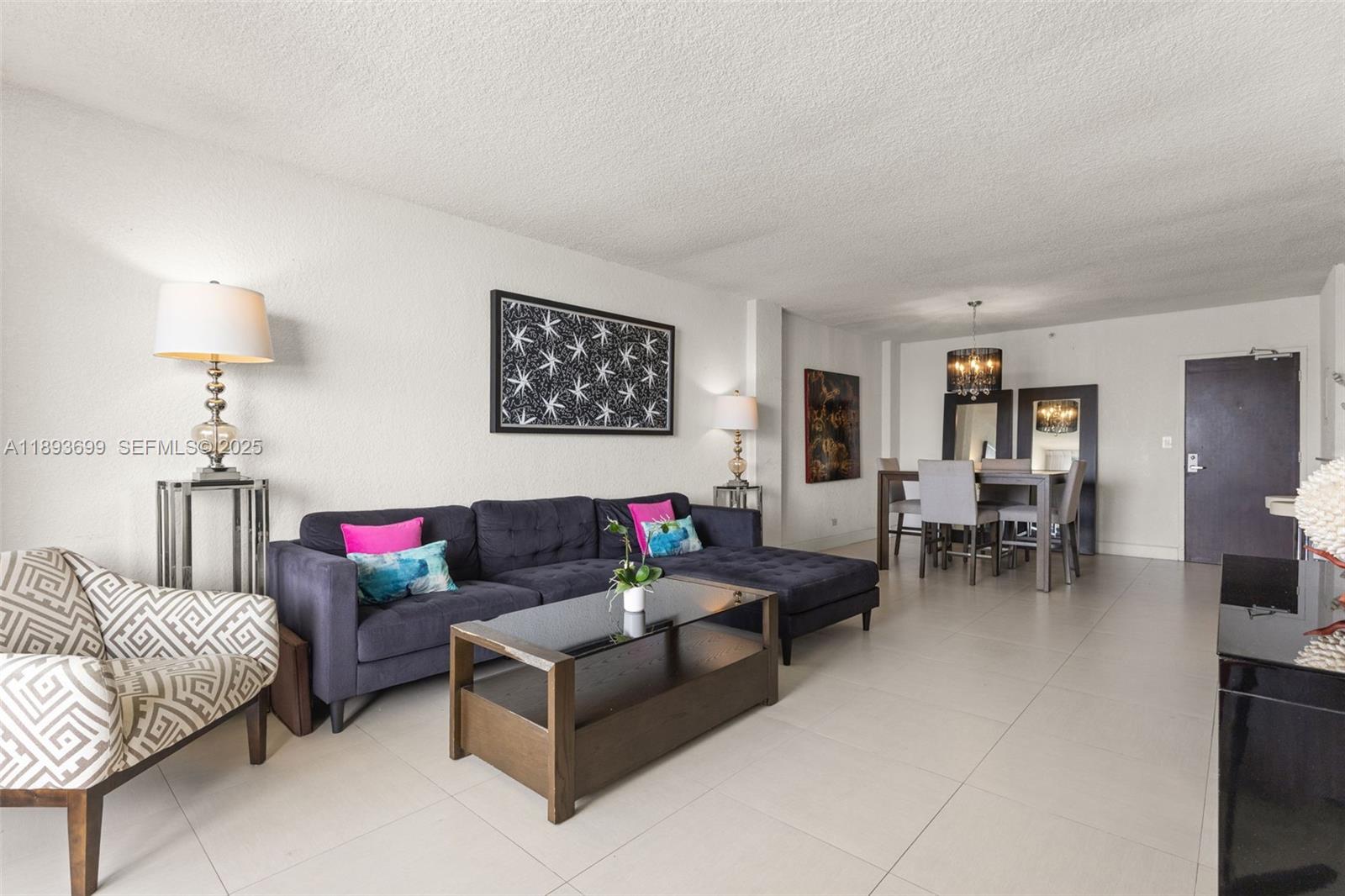 1500 Bay Road, Unit 1122S Miami Beach, FL 33139 - Photo 4 of 32 a living room with furniture and a table