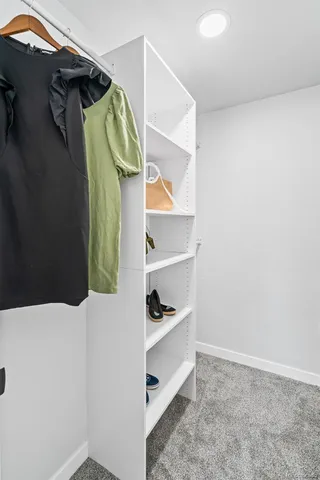 a bathroom with a toilet a window and shower