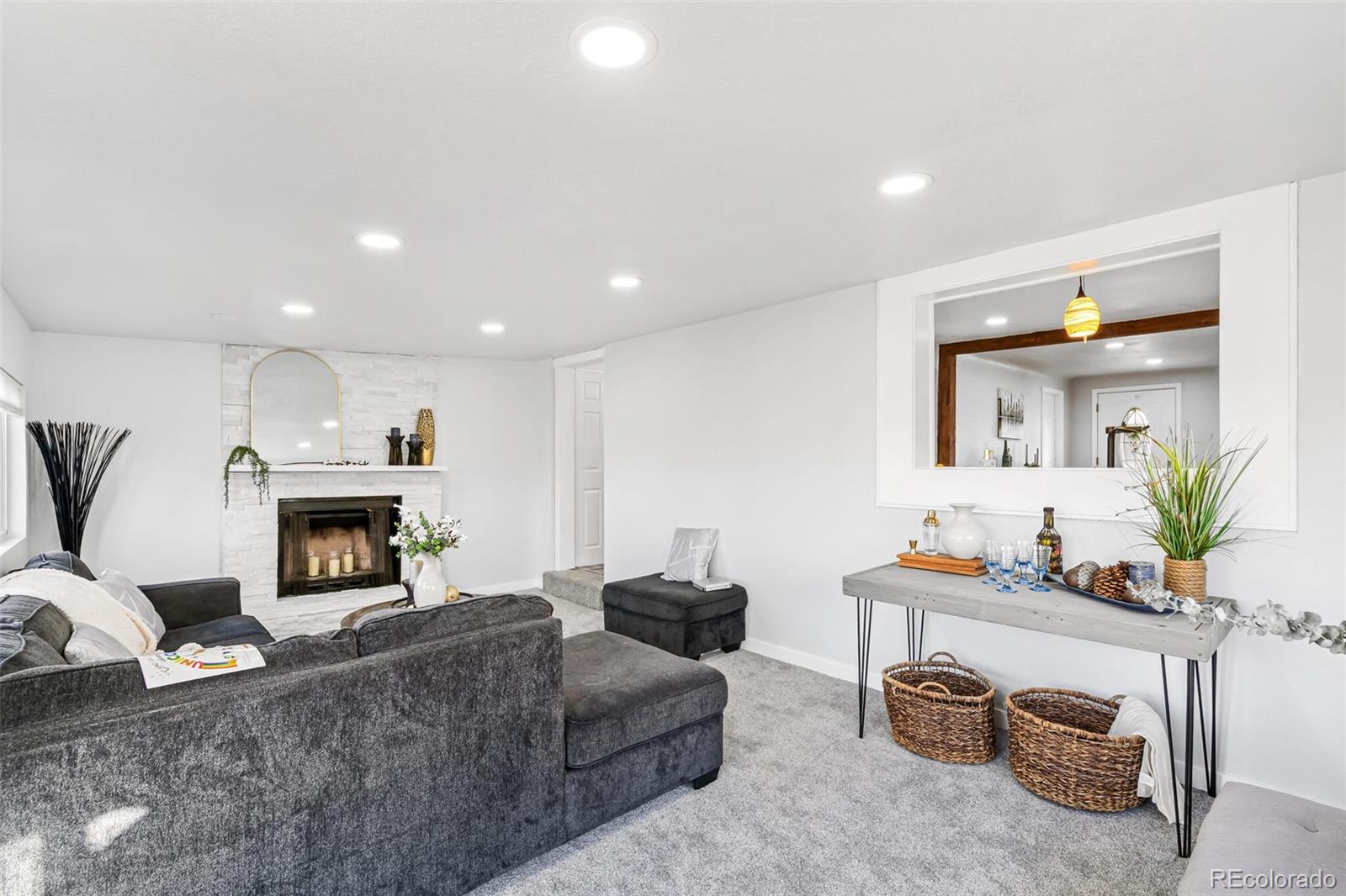 4831 Depew Street Denver, CO 80212 - Photo 17 of 35 a living room with furniture a fireplace and a flat screen tv