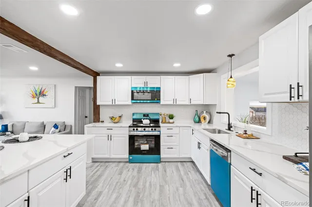 a kitchen with a sink stove and white cabinets