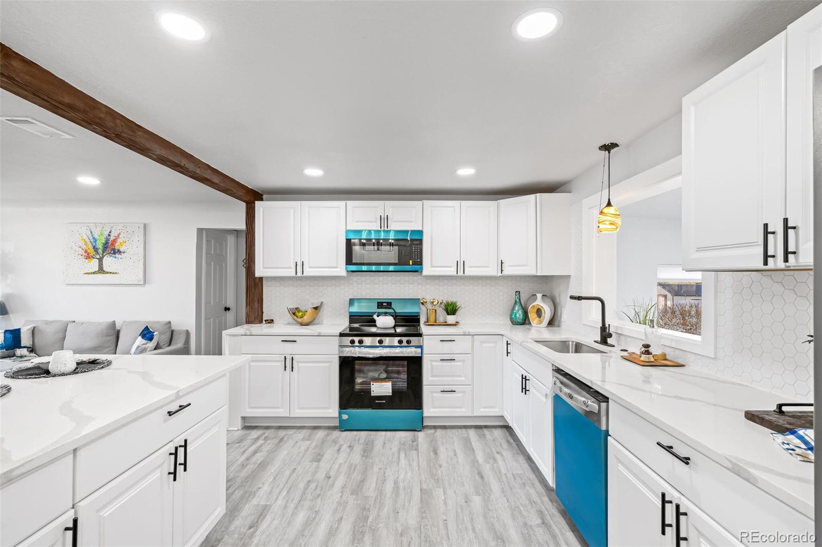 4831 Depew Street Denver, CO 80212 - Photo 24 of 35 a kitchen with a sink a stove refrigerator and cabinets