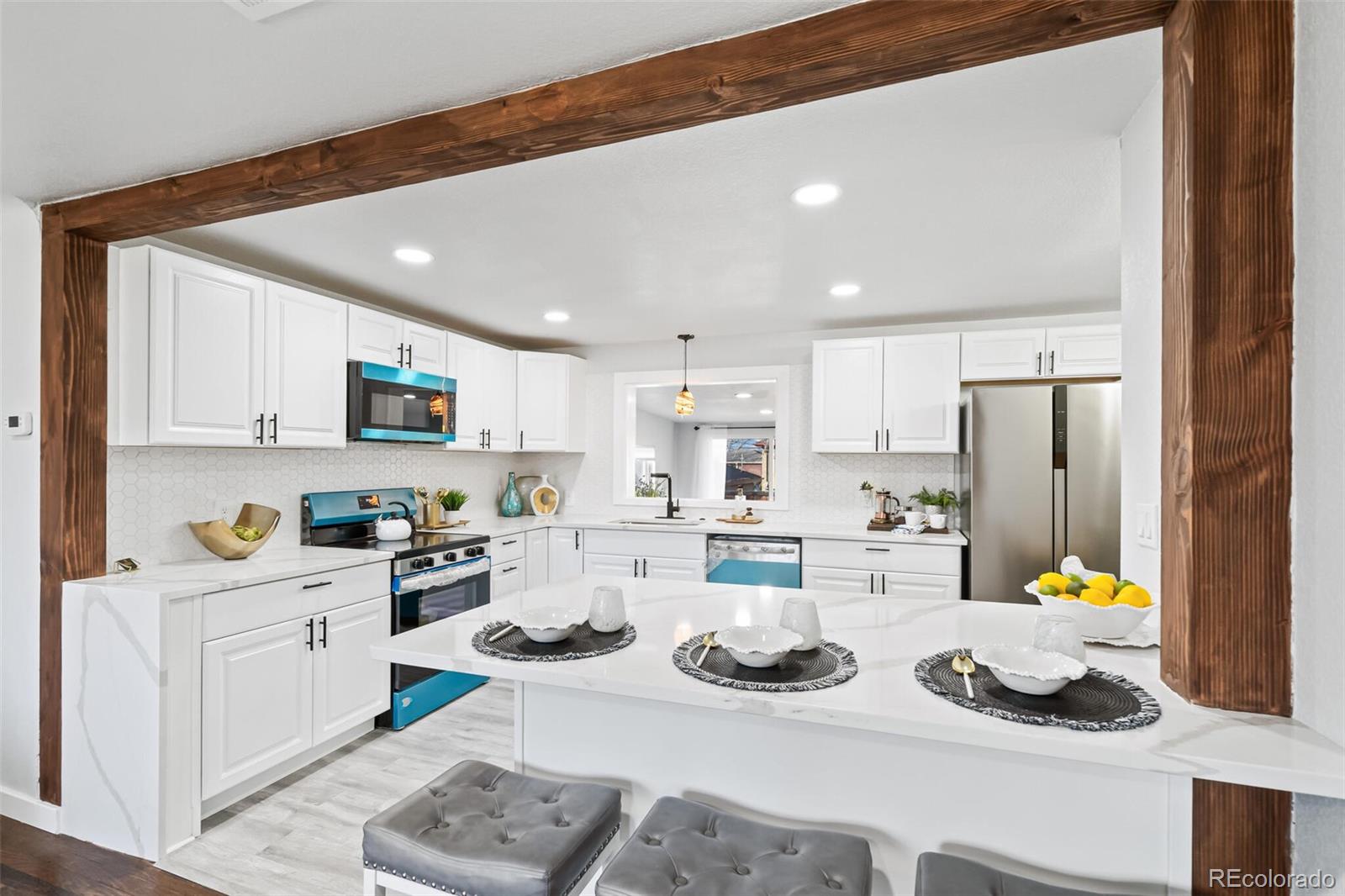 4831 Depew Street Denver, CO 80212 - Photo 25 of 35 a kitchen with a sink stove and white cabinets