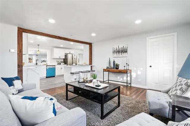a living room with furniture kitchen view and a table