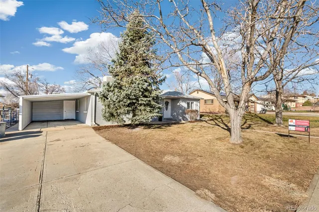 a front view of a building with trees and snow