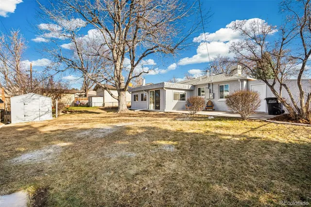 a front view of residential houses with yard and covered with trees