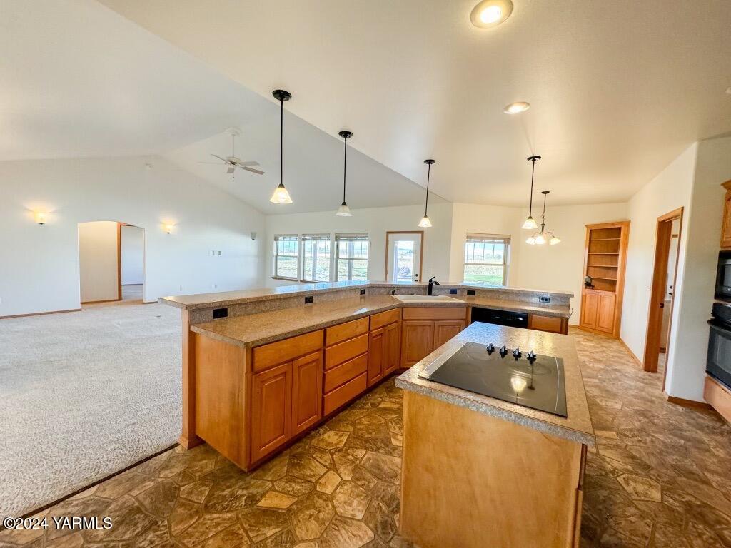 699 Alexander Road Sunnyside, WA 98944 - Photo 15 of 27 a kitchen with stainless steel appliances granite countertop a sink a counter top space cabinets and a couch