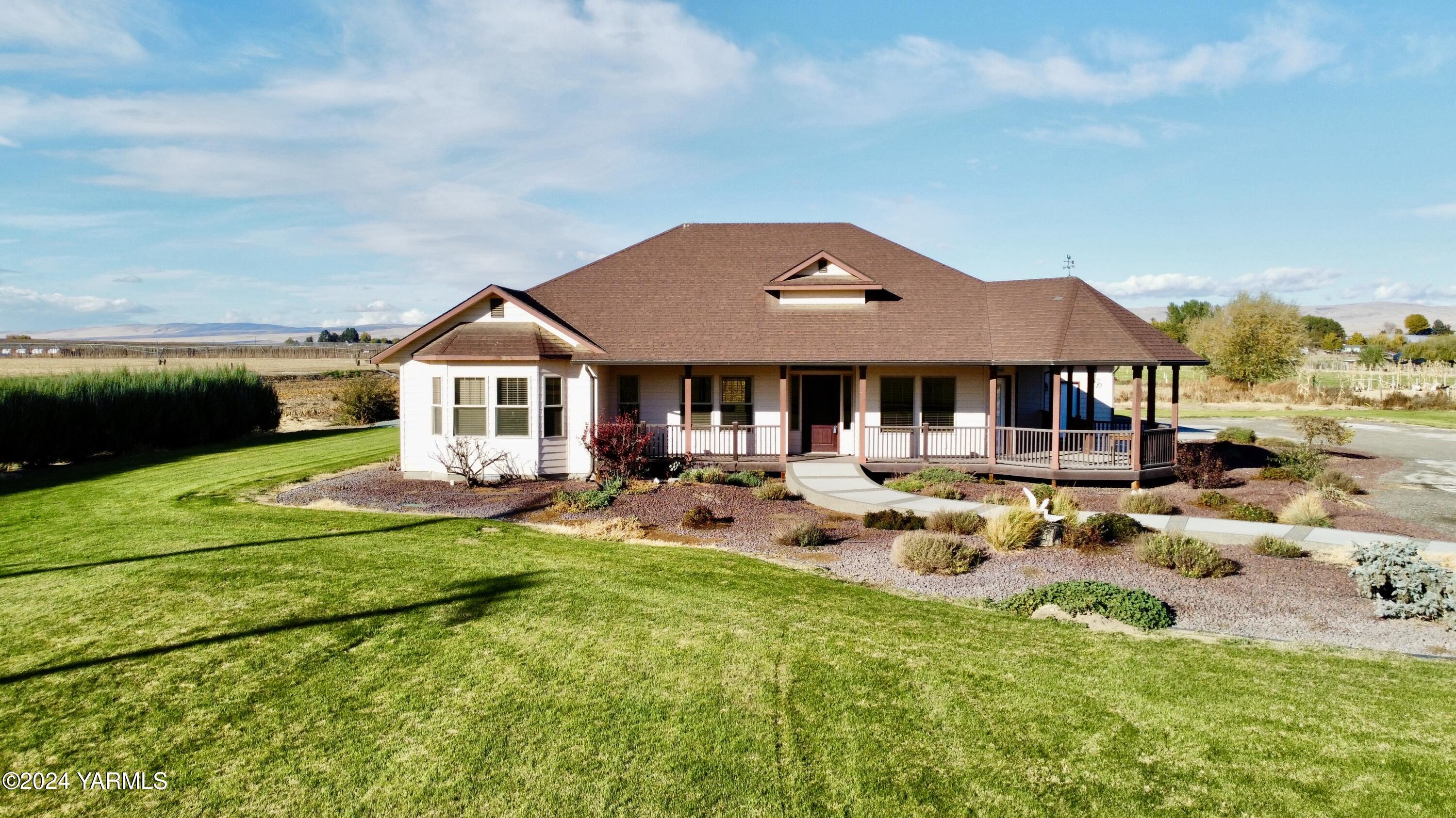 699 Alexander Road Sunnyside, WA 98944 - Photo 2 of 27 a front view of a house with swimming pool having outdoor seating