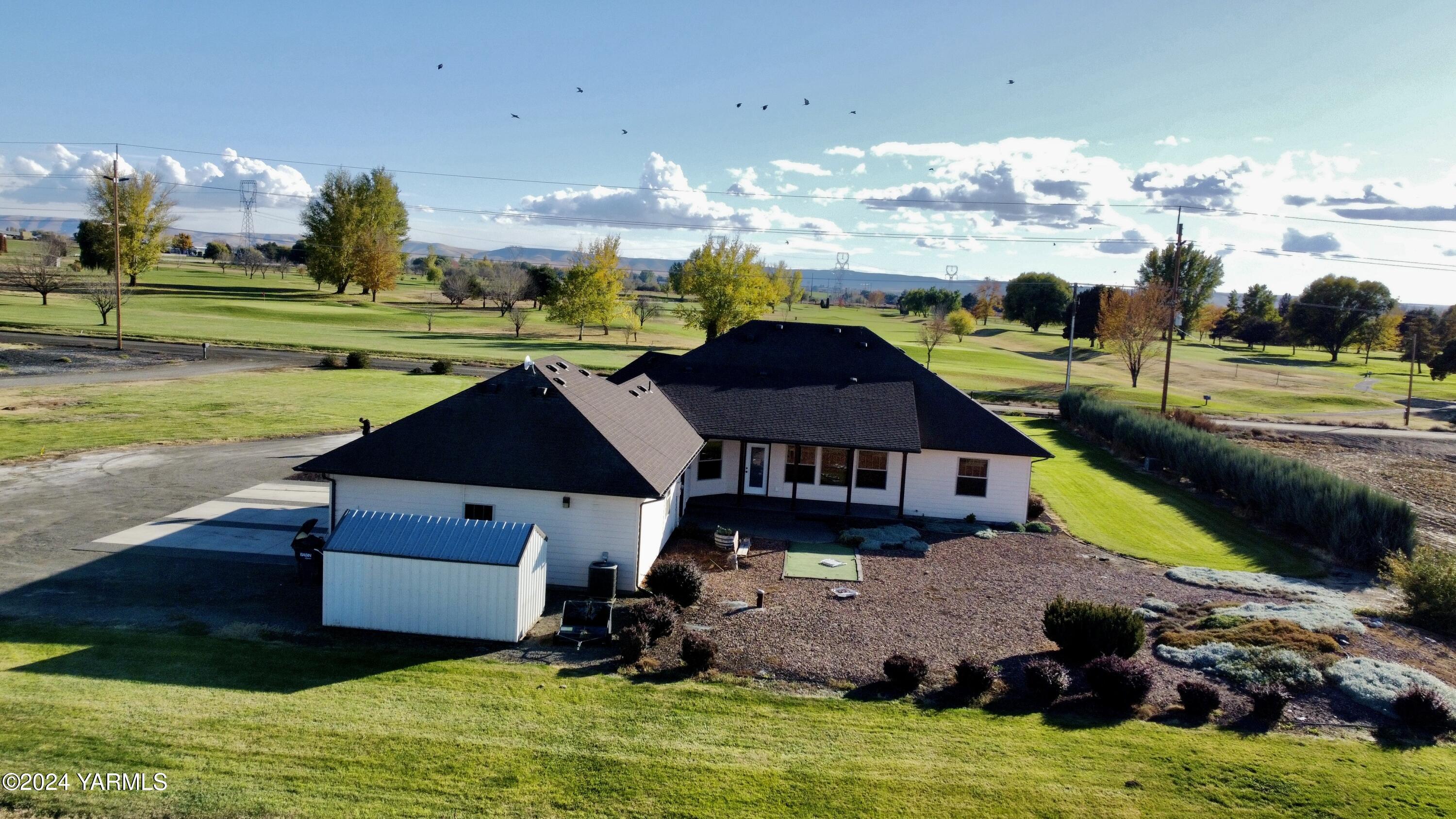 699 Alexander Road Sunnyside, WA 98944 - Photo 24 of 27 a aerial view of a house with swimming pool yard and outdoor seating
