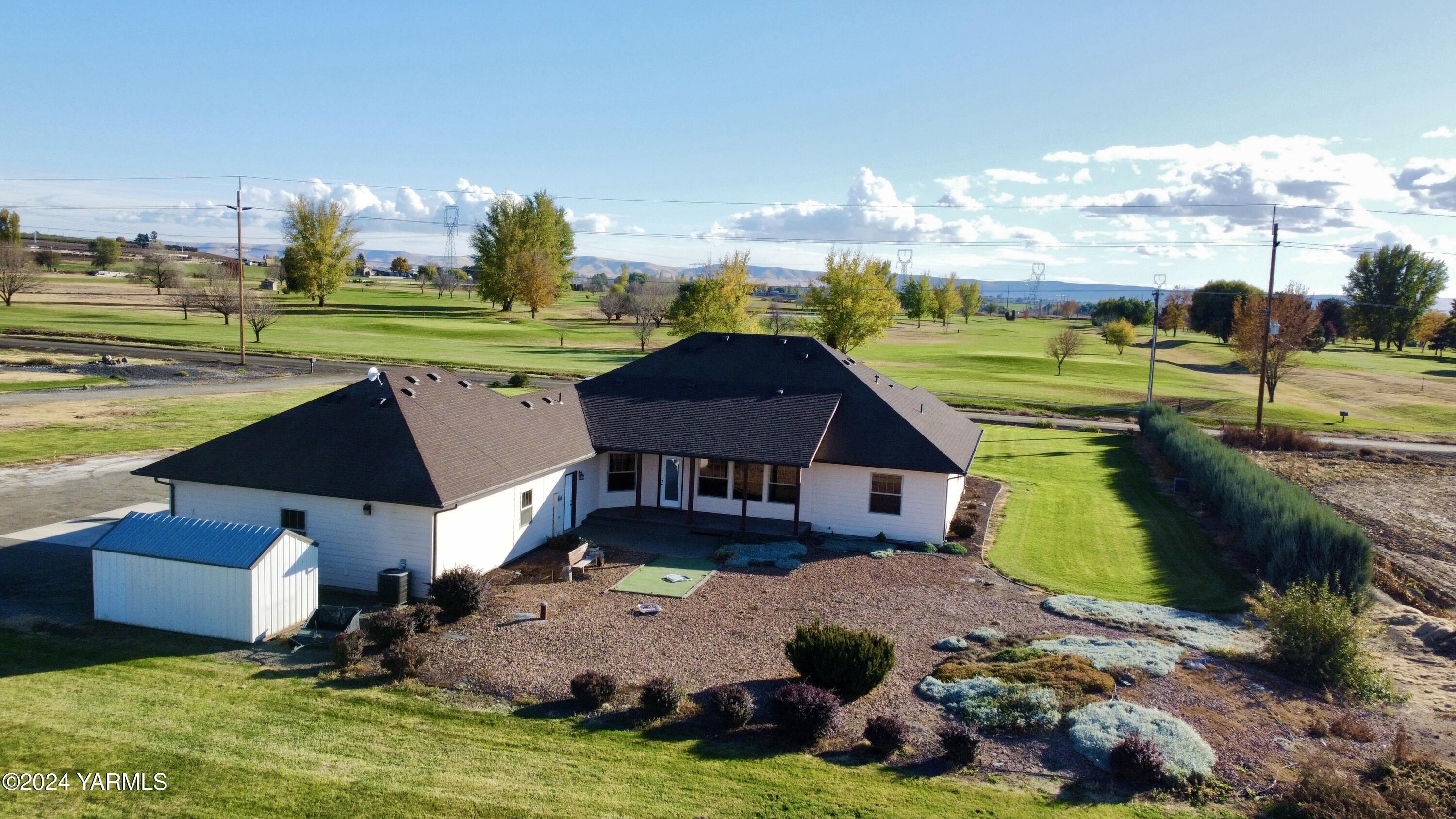 699 Alexander Road Sunnyside, WA 98944 - Photo 7 of 27 an aerial view of a house with garden space and street view