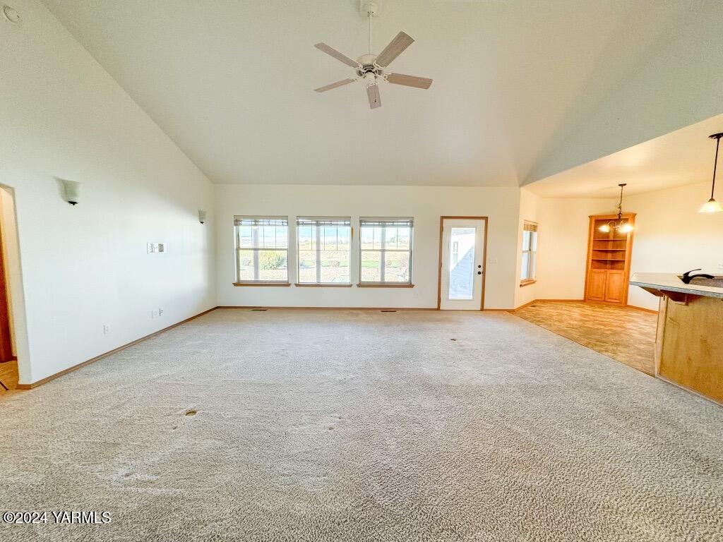699 Alexander Road Sunnyside, WA 98944 - Photo 10 of 27 an empty room with chandelier fan and windows