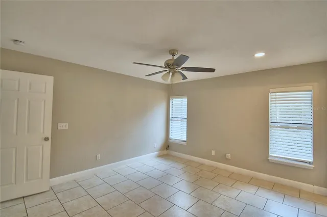 a view of a room with window and chandelier fan