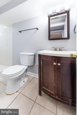 a bathroom with a toilet a sink and mirror
