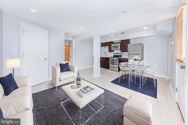 a living room with furniture and a rug