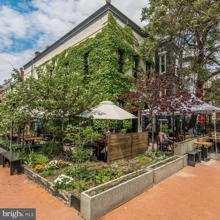 a view of a backyard with plants and patio