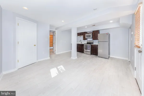 a view of a kitchen with a sink a refrigerator and window