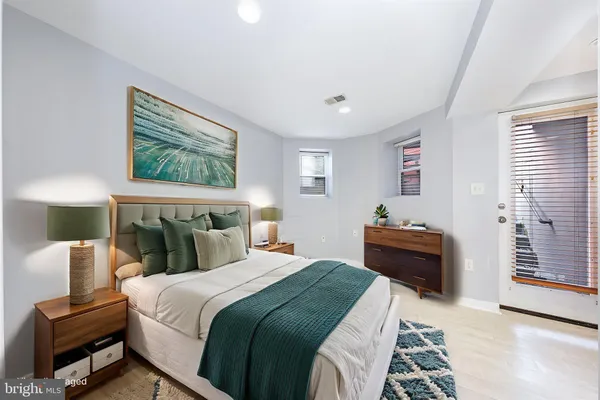 a bedroom with bed and wooden floor