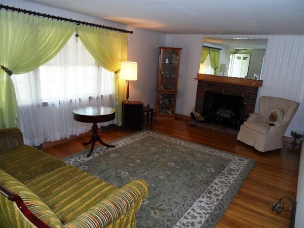 25 Eaton Road Framingham, MA 01701 - Photo 2 of 11 a bed sitting in a room next to a window