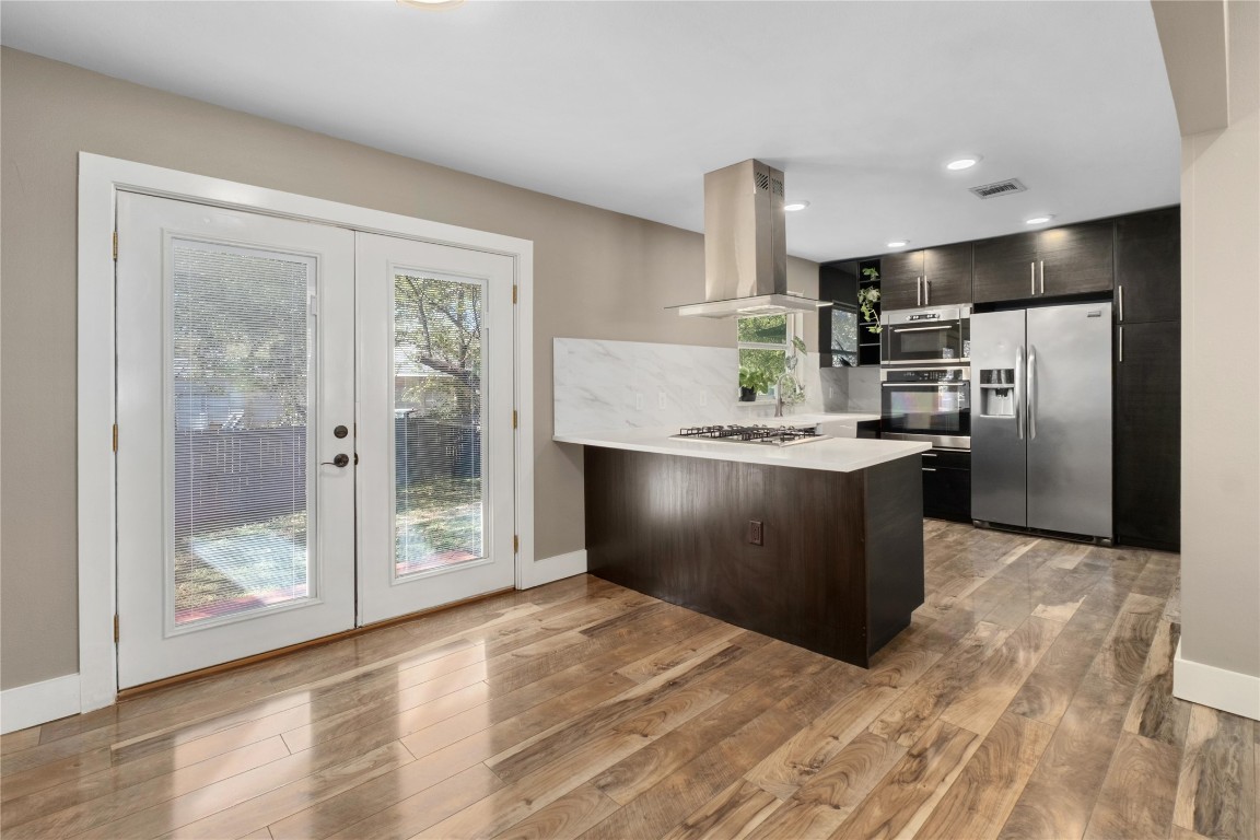 1204 Eleanor Street Austin, TX 78721 - Photo 12 of 26 a kitchen with granite countertop a refrigerator and a sink