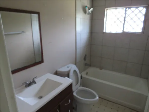 a bathroom with a sink a toilet and bathtub
