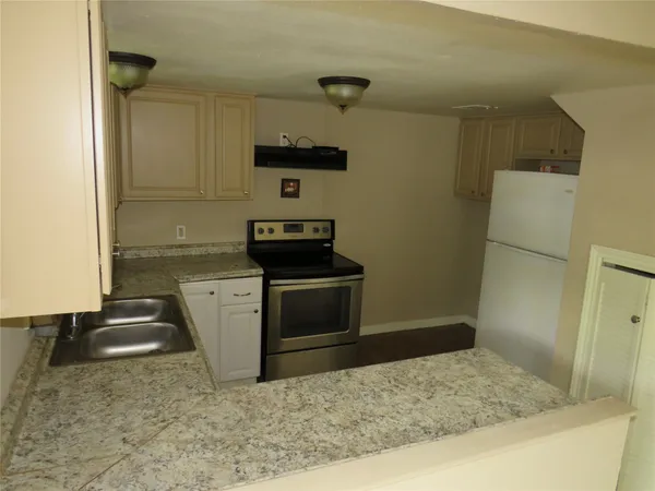 a kitchen with a sink window and cabinets