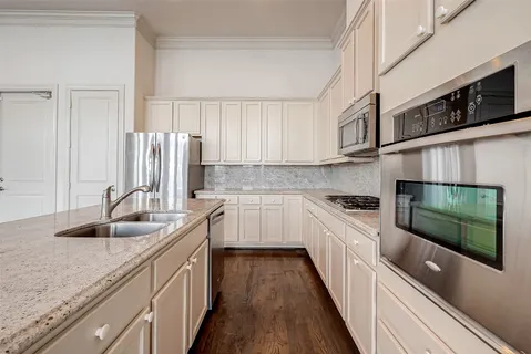 a kitchen with stainless steel appliances granite countertop a sink stove and cabinets