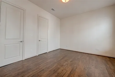a view of an empty room and wooden floor