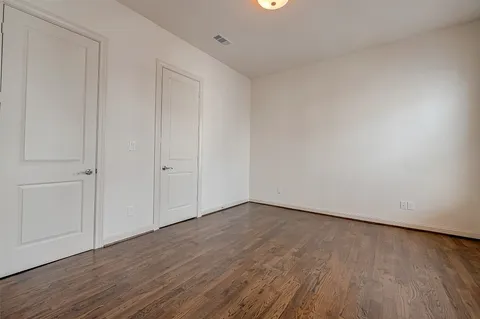 a view of an empty room and wooden floor