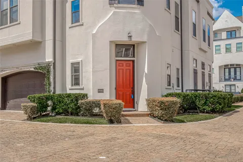 a view of a house with potted plants