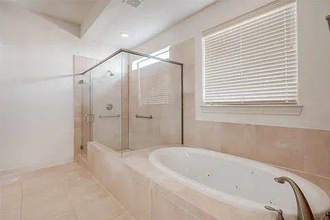 a bathroom with a bathtub and a shower