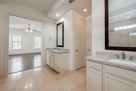 a bathroom with a sink a mirror and a shower