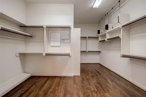 a view of walk in closet with empty racks