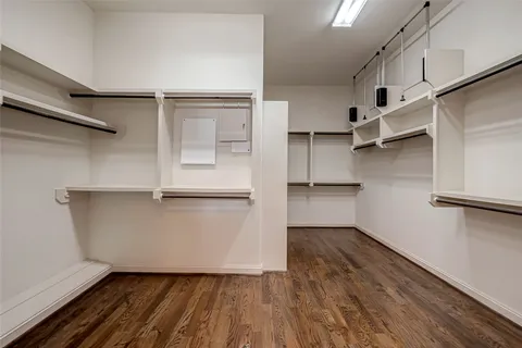 a view of walk in closet with empty racks