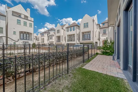 a view of a brick building next to a yard