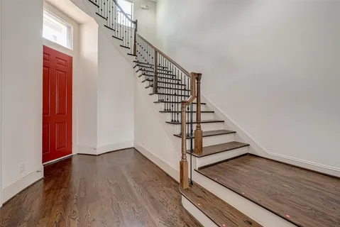 a view of entryway and hall with wooden floor