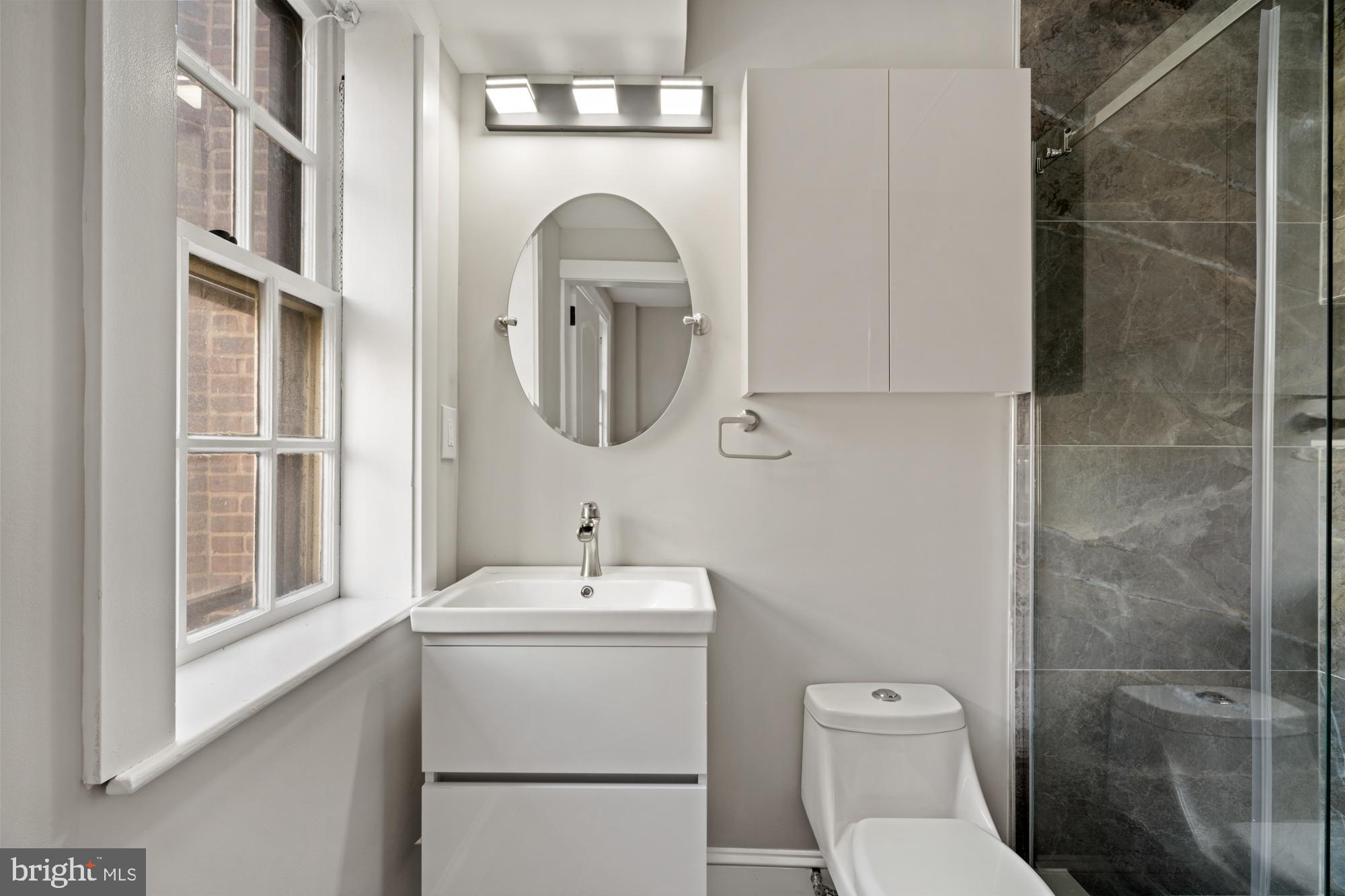 415 City Avenue, Unit I2 Merion Station, PA 19066 - Photo 17 of 35 a bathroom with a toilet sink shower and mirror