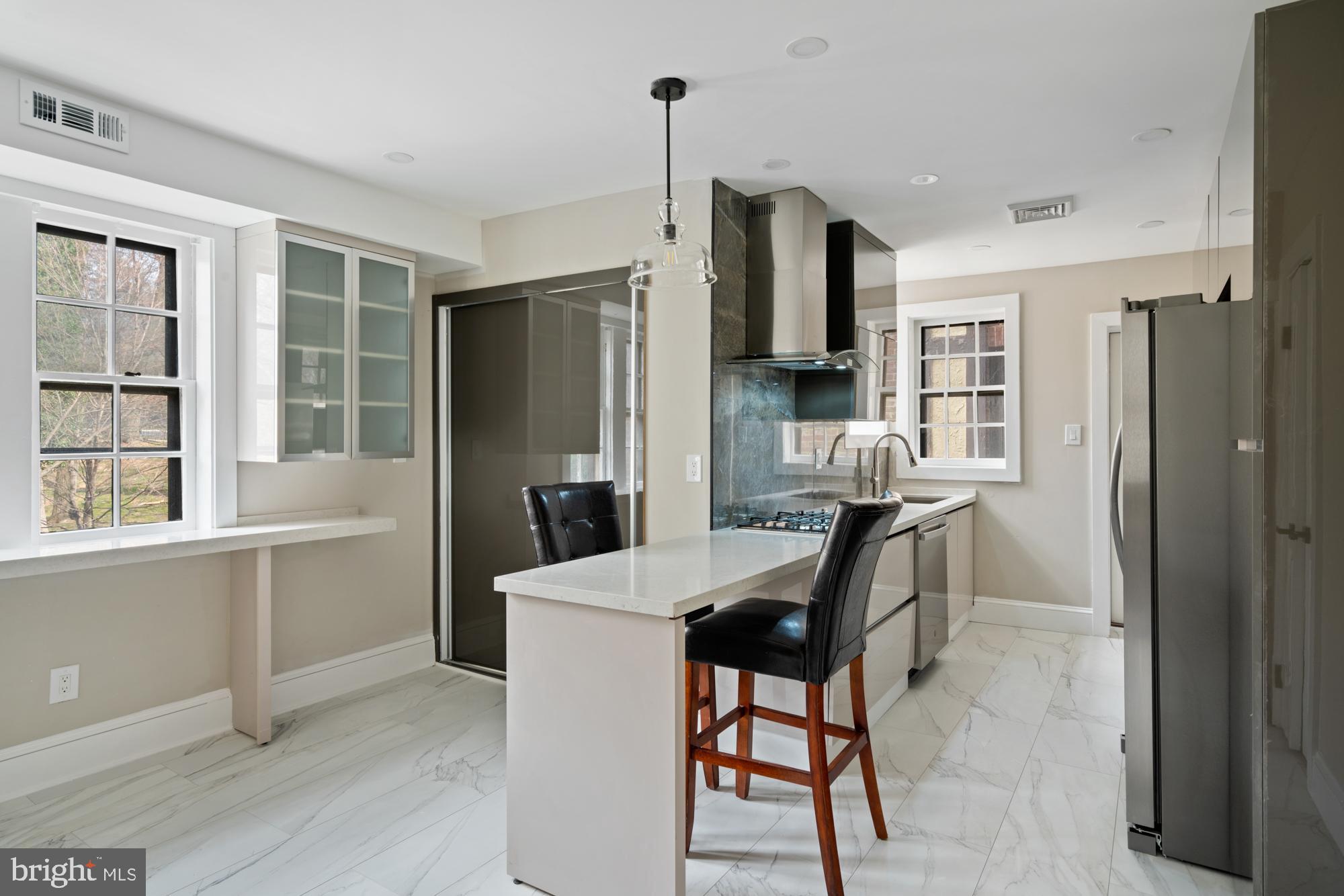 415 City Avenue, Unit I2 Merion Station, PA 19066 - Photo 9 of 35 a kitchen with refrigerator cabinets and wooden floor
