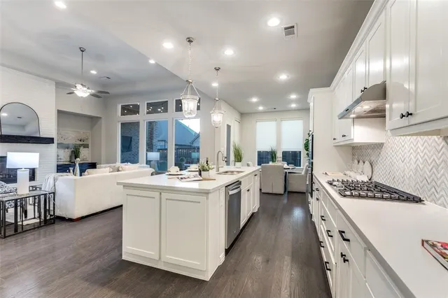 a kitchen with counter top space a sink stainless steel appliances and cabinets