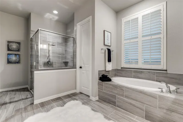 a bathroom with a bathtub and a shower