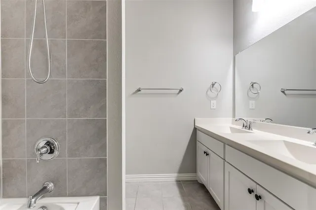 a bathroom with a granite countertop sink a shower and a mirror