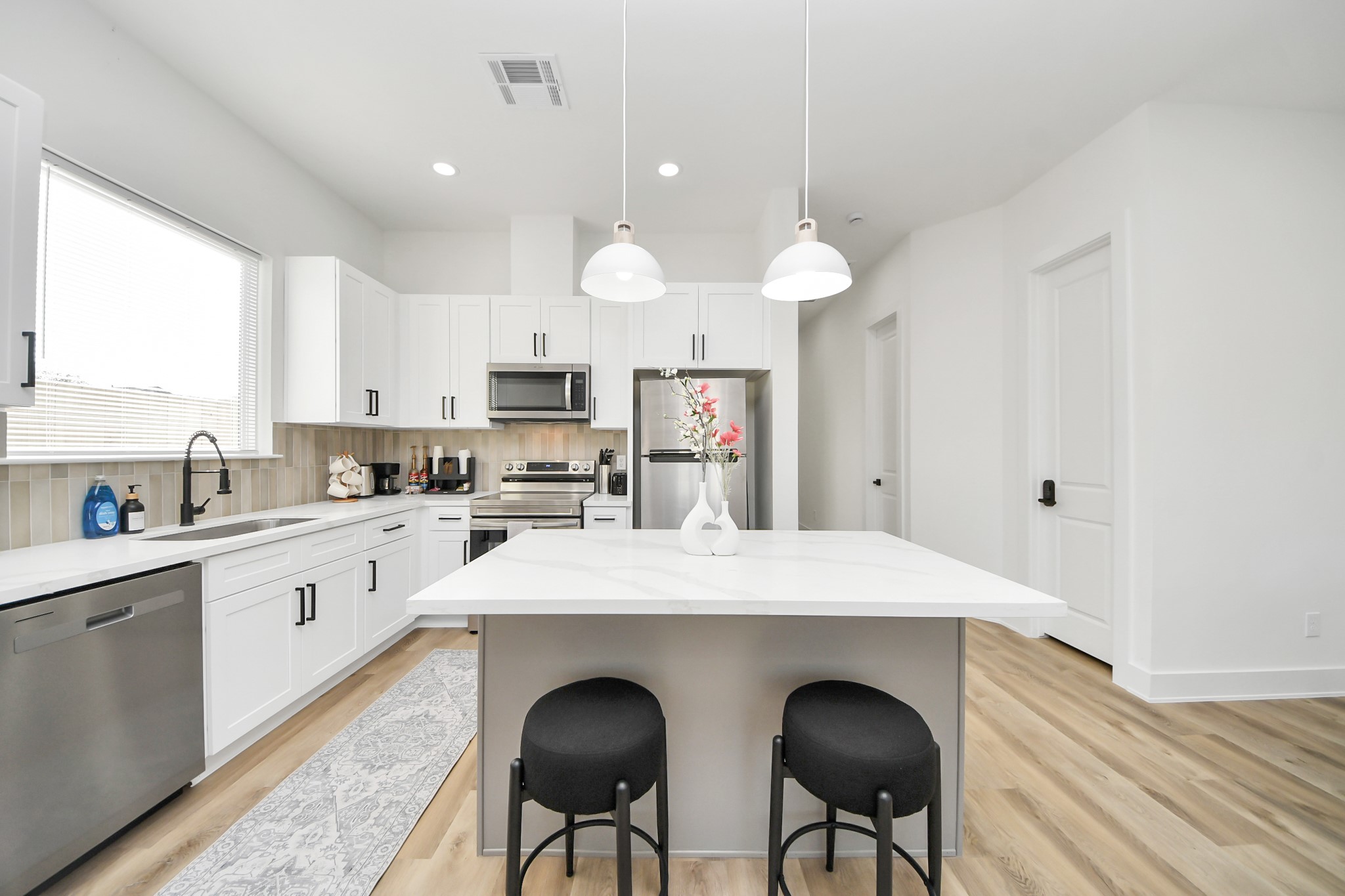 3909 Maggie Street Houston, TX 77051 - Photo 14 of 49 a large kitchen with granite countertop a stove a sink dishwasher a dining table and chairs with wooden floor