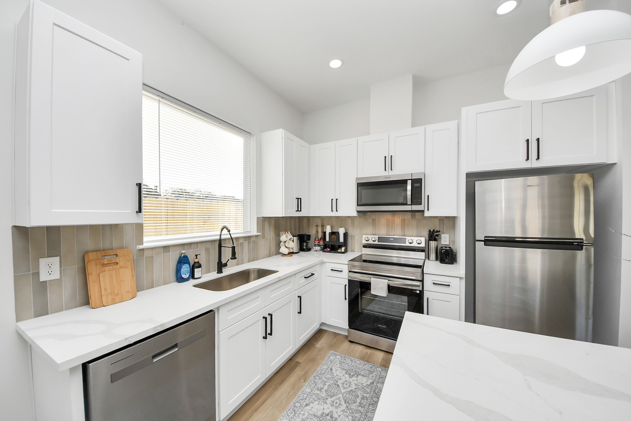 3909 Maggie Street Houston, TX 77051 - Photo 15 of 49 a kitchen with a refrigerator a sink and a stove