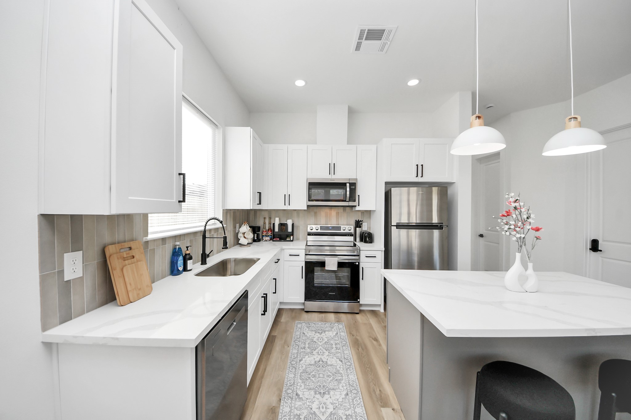 3909 Maggie Street Houston, TX 77051 - Photo 16 of 49 a kitchen with a sink a kitchen island and stainless steel appliances
