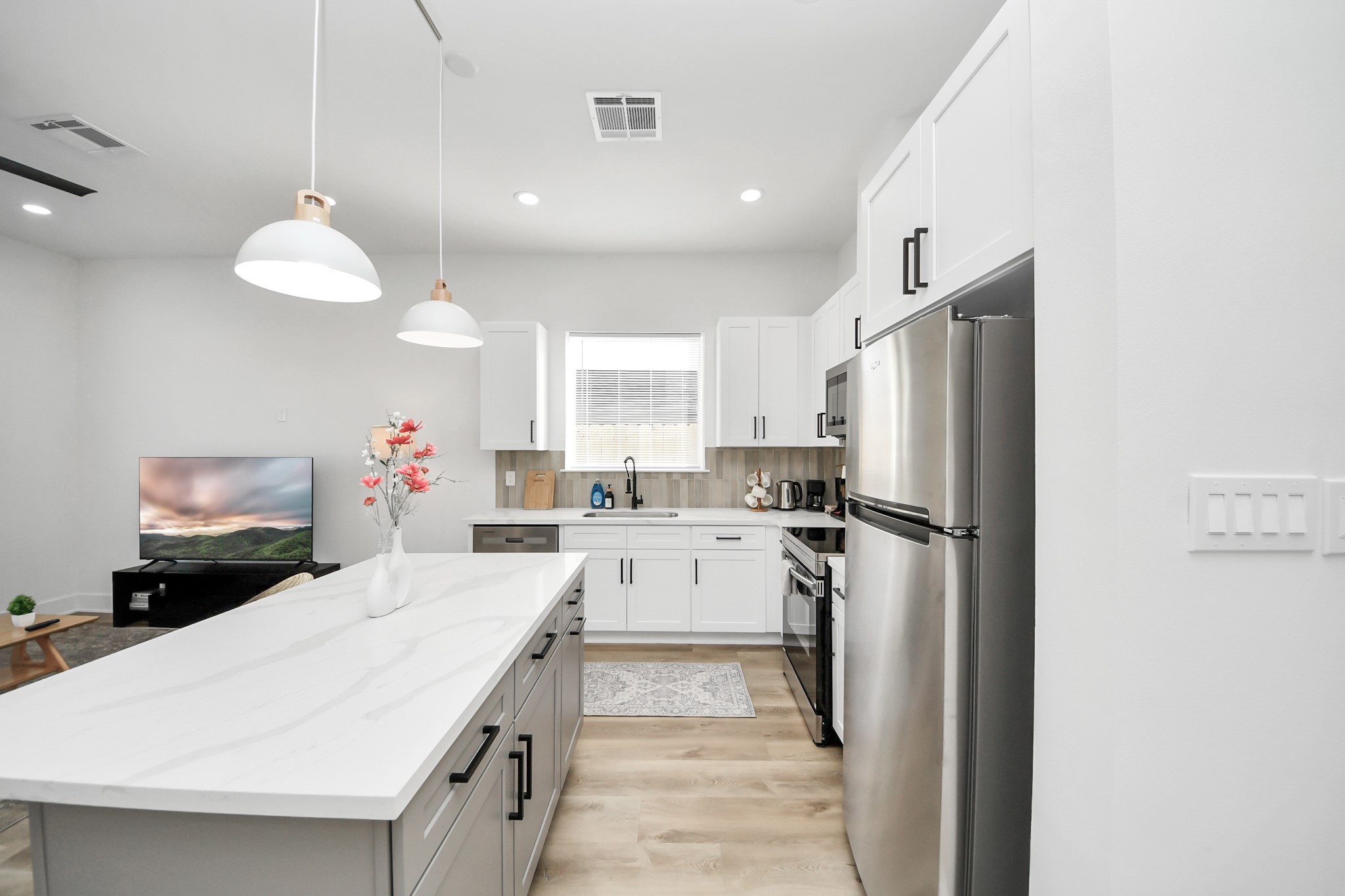 3909 Maggie Street Houston, TX 77051 - Photo 19 of 49 a kitchen with a refrigerator a sink and dishwasher with white cabinets