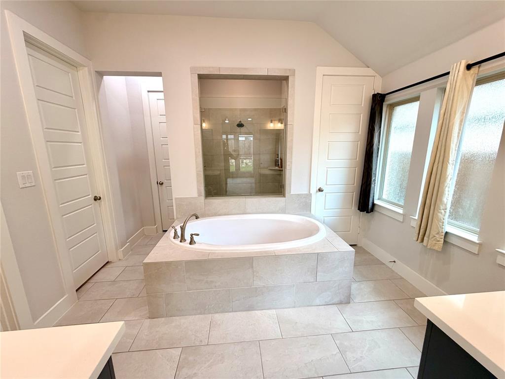 3810 Rutledge Drive Melissa, TX 75454 - Photo 19 of 25 Spacious bathroom featuring a built-in soaking tub with brushed nickel fixtures, a large walk-in glass shower enclosure, and light-toned tile flooring