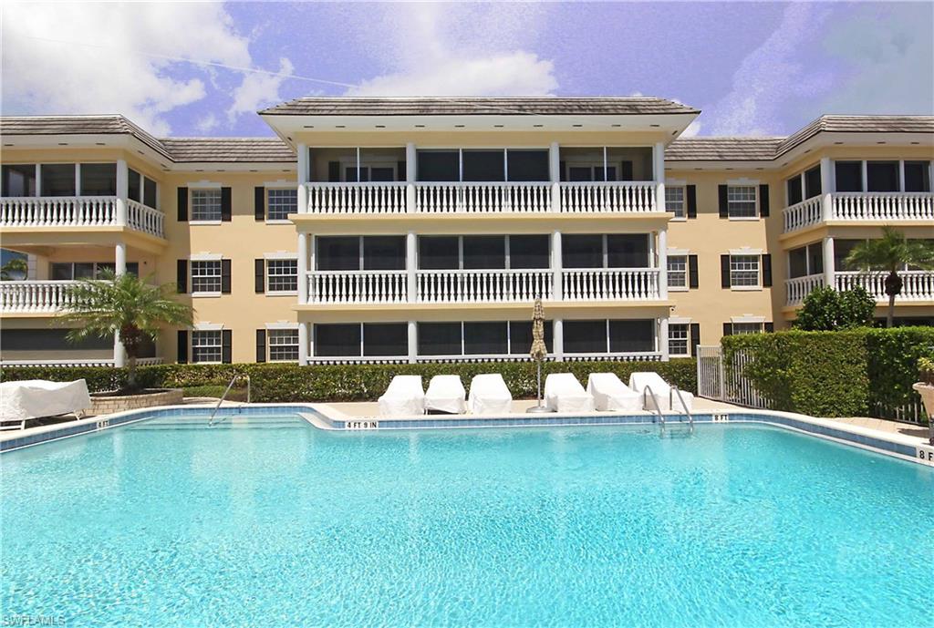 a front view of a building with a garden and plants