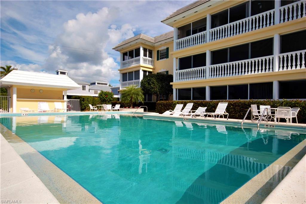 666 3rd Street South, Unit 201 Naples, FL 34102 - Photo 14 of 19 a front view of a house with swimming pool having outdoor seating