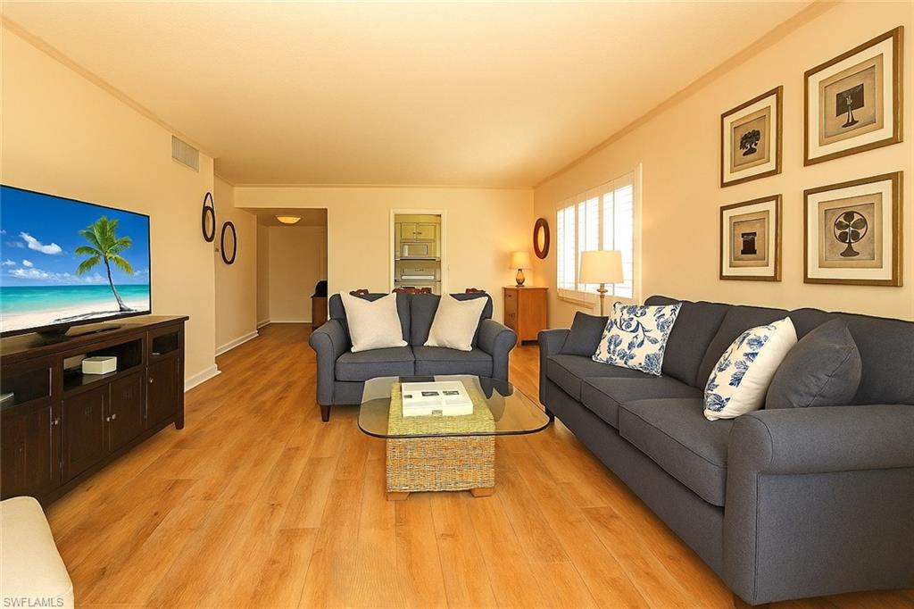 666 3rd Street South, Unit 201 Naples, FL 34102 - Photo 3 of 19 a living room with furniture and a fireplace