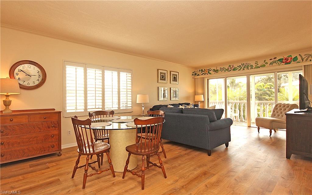666 3rd Street South, Unit 201 Naples, FL 34102 - Photo 5 of 19 a living room with furniture and a large window