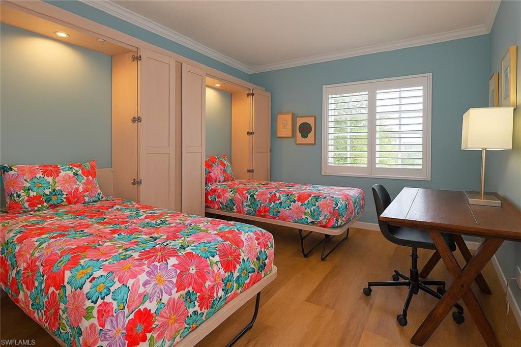 666 3rd Street South, Unit 201 Naples, FL 34102 - Photo 8 of 19 a bedroom with a bed and a table in it