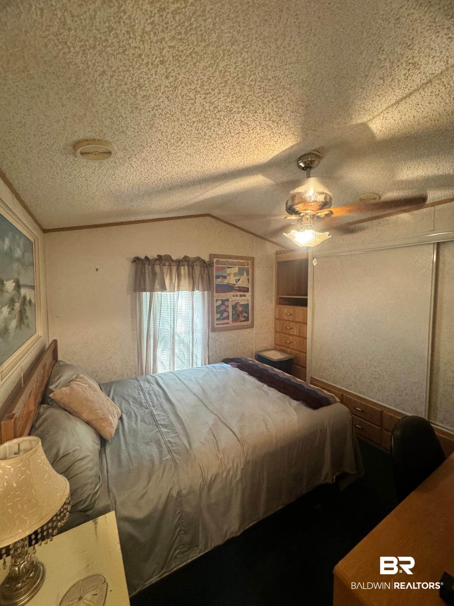 112 Horn Drive Lillian, AL 36549 - Photo 7 of 30 Bedroom with a textured ceiling, ceiling fan, and lofted ceiling